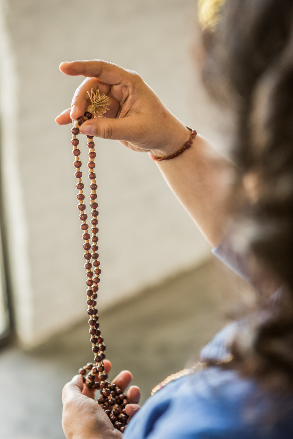 While telling the beads of the japa mala, why is it advised not to touch it  with the index finger? - Quora